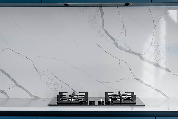 istock Gas cooktop. Marble backsplash. Minimal kitchen 2232818316