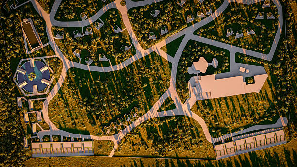 A top-down aerial view of a residential complex at the beach showcasing an organized green community with roads, modern structures, and lush vegetation, offering an idyllic, peaceful, and contemporary environment.