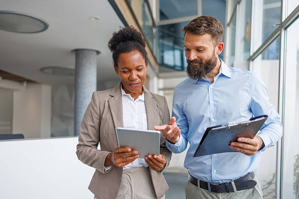 istock Businesspeople collaborating using digital tablet and clipboard in modern office 2232823513