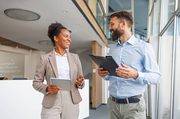 istock Business colleagues walking and talking in modern office 2232823567
