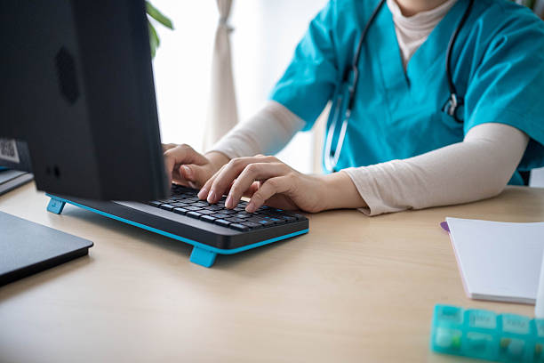 istock Doctor Updating Patient’s Treatment File 2232823812
