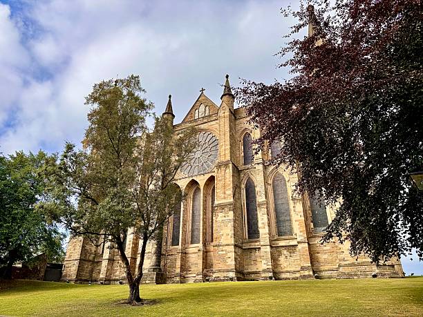 istock Durham Cathedral with grass and trees against cloudscape 2232826406