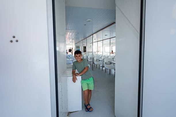 Child relaxing on a ferry, enjoying a scenic boat trip along the beautiful coast of girona, roses, spain, with smiles and happiness