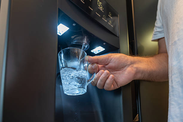 istock A glass is being filled with water from a modern water dispenser. 2232833222