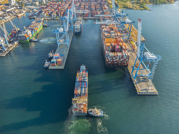 istock Aerial view of Cargo Container Ship in transit with tugboat. 2232840510