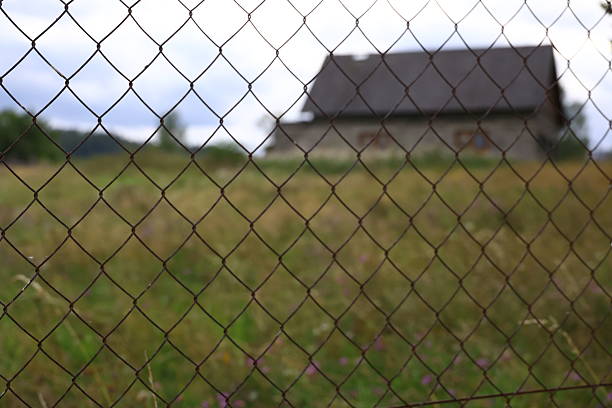 istock Blurred house behind fence 2232843497