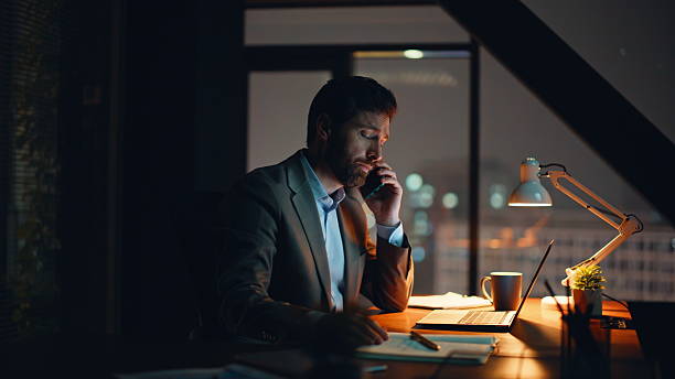 istock Disappointed manager calling phone sitting at late office workplace closeup 2232844517