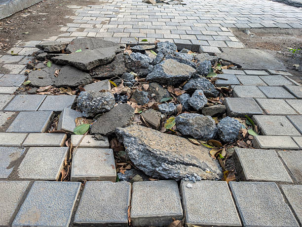 istock Damaged Sidewalk with Broken Tiles and Debris 2232845090