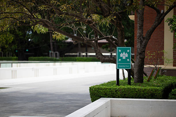istock Green assembly point sign in a peaceful public park 2232851457