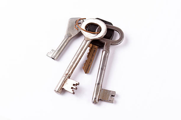 istock Old worn metal keys key bundle on white background, vintage house keyring bundle different shapes, isolated collection of keys together, household garage, basement, house key set, objects cut out 2232851633