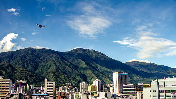 A small plane flies over the Caracas Valley