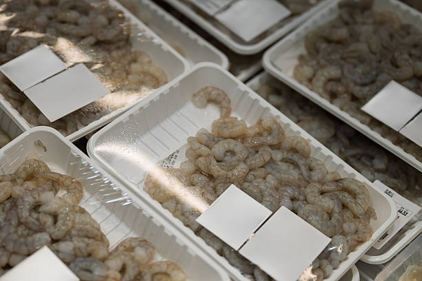 istock Fresh Shrimp Displayed in Plastic Trays at a Market Stall 2232852808