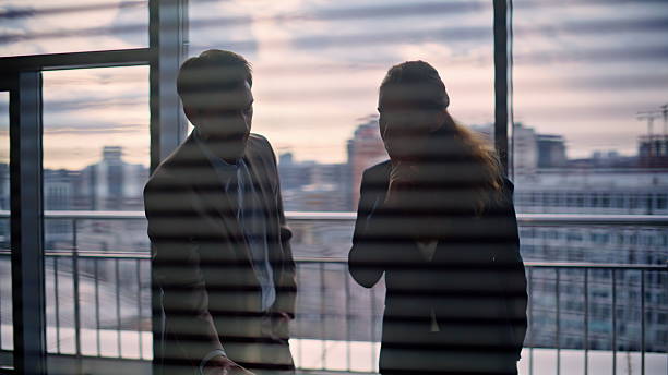 istock Corporate employees discussing project shaking hands at city architecture view 2232852931