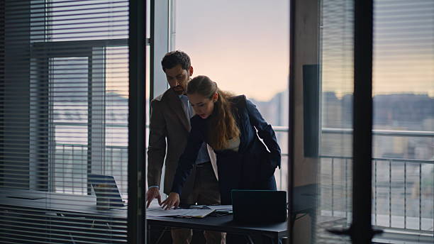 istock Positive businesspeople doing paperwork in large windows office. Bosses working 2232855145