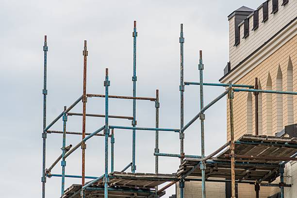 istock Scaffolding structure in an ongoing urban construction, with building materials and a multi-story building under construction Overcast daytime lighting 2232856015