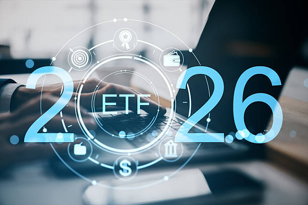 istock ETF technology interface with stock market icons and digital numbers overlayed on businessman's hands typing on laptop at office desk background. 2232857536