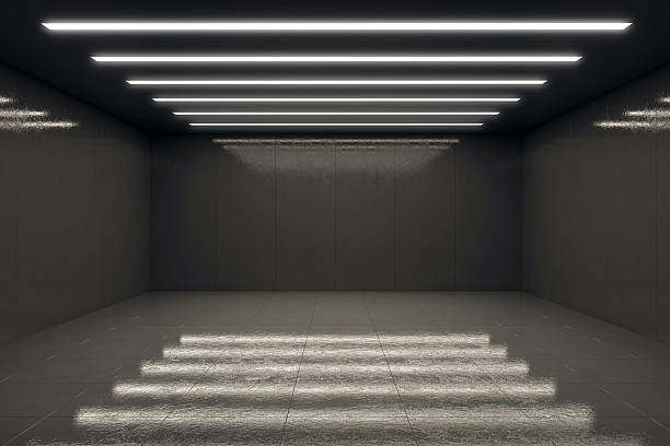 istock Empty modern dark room with reflective floor and linear ceiling lights, ideal for product presentation or branding mockup display template. 3D Rendering 2232857766