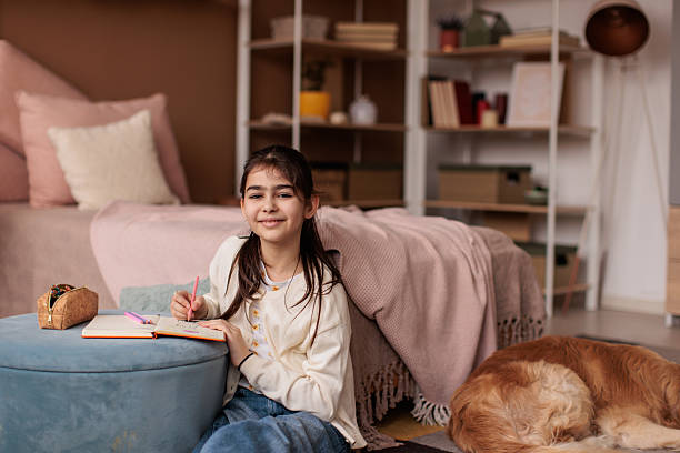 istock Girl doing homework in her room at home 2232858971