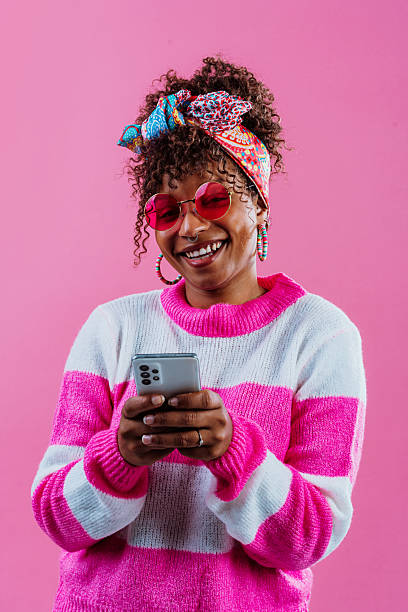 istock Enthusiastic influencer taking a selfie with smartphone on pink 2232859998