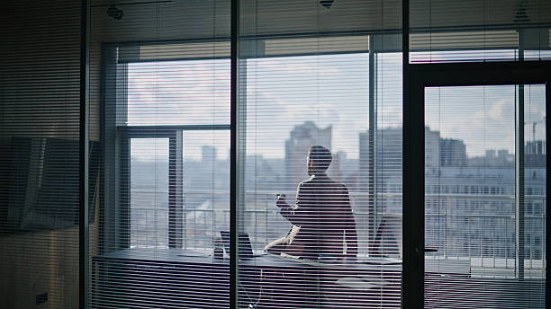 istock Confident entrepreneur sipping espresso sitting table at window private room 2232860070
