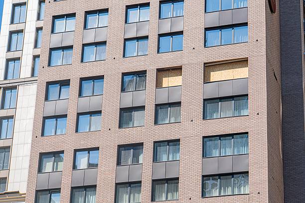 istock Modern, multi-storied building with a mix of brickwork and glass panels Curtained windows, gray concrete, black metal frames, red bricks, soft shadows, urban detail, cityscape, no contextual signs 2232861630