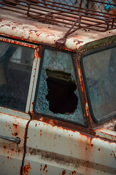 part of an old rusty car with broken glass