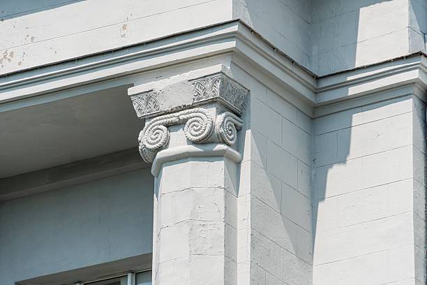 istock Close-up of a modern, institutional or governmental building with classical elements The image focuses on an ornate column, displaying intricate carvings at its top Daytime, muted light beige tones 2232868283