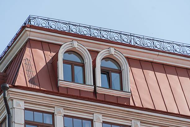 istock Close-up view of a classical urban structure with arched windows, white molding, and aged roof tiles Shadowy right side suggests left-side lighting Straightforward photograph style highlights archi 2232868472
