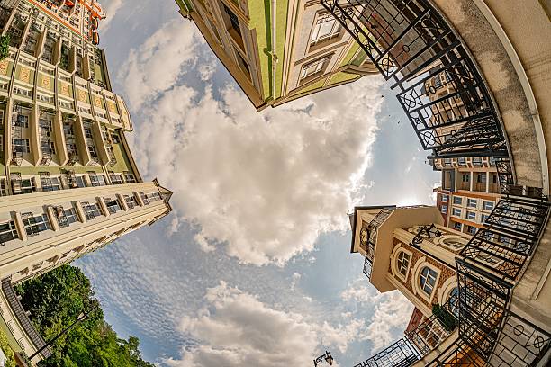 istock Panoramic cityscape view from a high vantage point, depicting diverse buildings in earthy tones beige, brown, with windows, balconies, air conditioning units Clear blue sky with scattered clouds c 2232868905