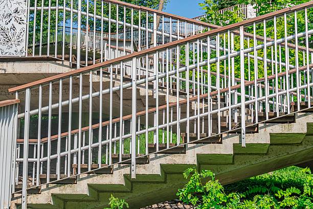 istock Summary Modern concrete staircase in urban park setting, with metal railings and natural lighting a 2232870310