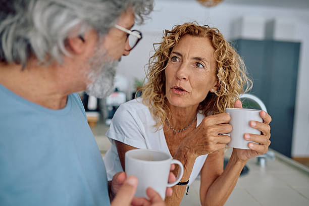 istock Senior couple talking and drinking coffee in kitchen 2232871334