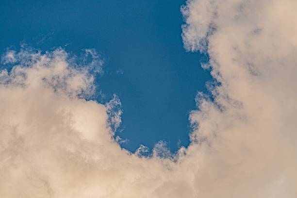 istock Scattered white clouds on a bright, clear blue sky Soft lighting suggests early morning or late afternoon No objects visible Realistic style focusing on natural elements 2232876264