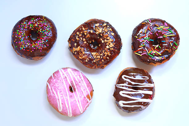 istock Assorted Donuts with Chocolate and Pink Frosting on White Background. 2232878118