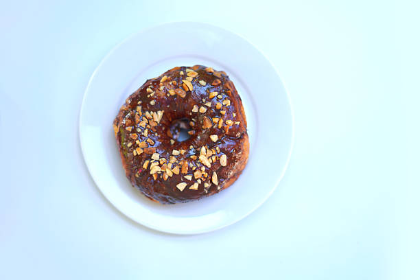 Crushed Nuts with chocolate donut on white plate