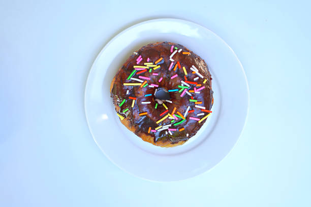 dish of colorful donut on white background