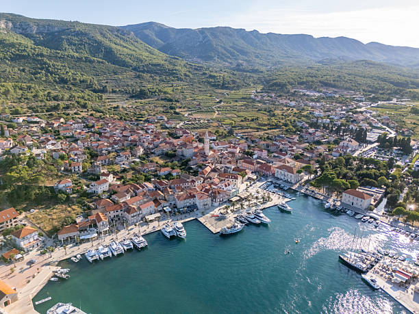 istock Coastal Town Harbor with Boats and Mountains 2232879500
