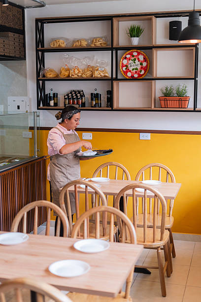 istock Restaurant owner gets ready to open the doors and start serving customers 2232880749