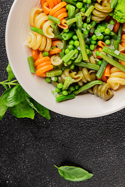 istock Trottole pasta vegetables green peas, green beans, kohlrabi cabbage, broccoli second course tasty snack fresh delicious gourmet food background on the table rustic food top view copy space 2232881965