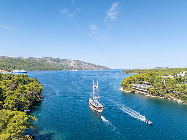 istock Sailing Ship and Motorboat in Coastal Bay 2232882121