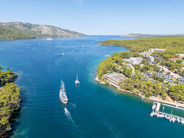 istock Sailing Ship and Motorboat in Coastal Bay 2232882123