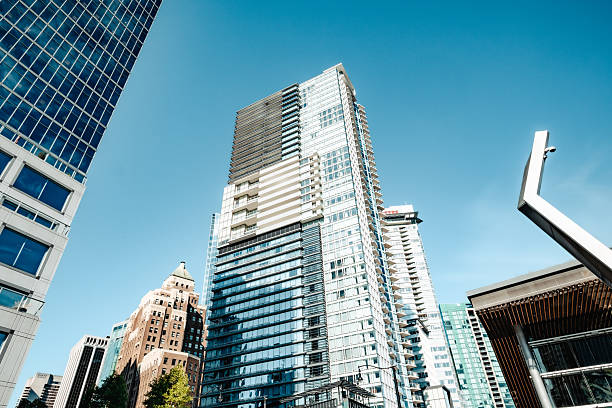 Modern city skyline looking up. Empty homes tax, speculation tax or gentrification. View from Jack Poole Plaza. Selective focus. Vancouver, BC, Canada - August 8 2025