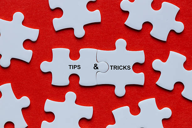 istock Tips and tricks symbol. Among the scattered puzzle pieces, two connected ones form the words 