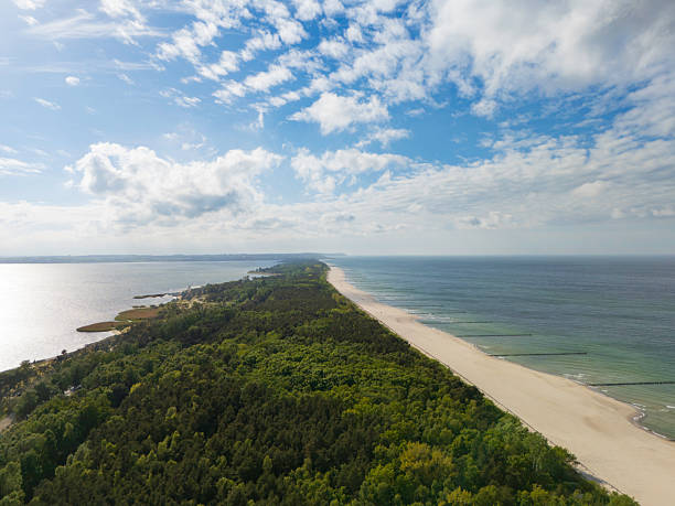 istock Scenic view of beach with sandy shore and gentle waves under a sunny sky 2232897468