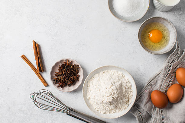 istock Baking ingredients flat lay with flour, eggs, sugar, and spices on marble surface. Copy space 2232899700