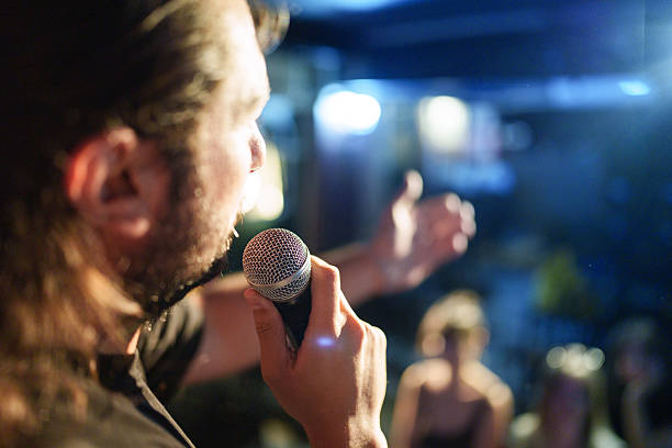 istock Close-up of performer speaking into microphone on stage 2232902881