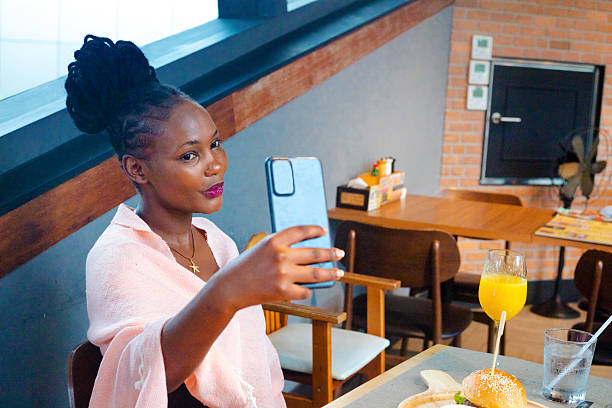 istock Young Kenyan woman taking  a selfie at lunch 2232903241