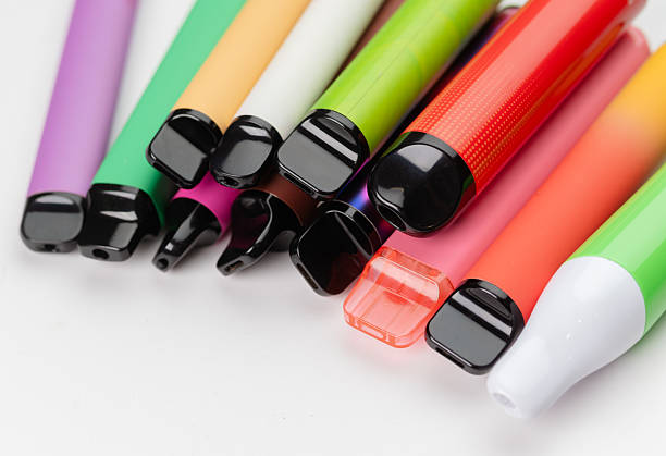 istock Colorful disposable vapes arranged close-up, modern electronic smoking devices in various bright colors. 2232904420