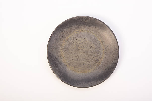 istock Beautiful ceramic plate placed on a white background, selective focus. Top view. 2232905208