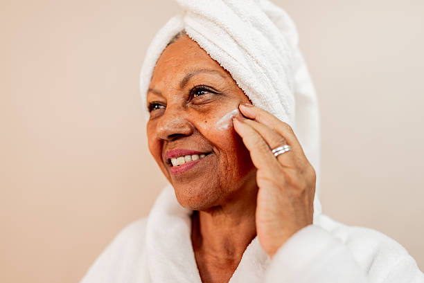 istock Senior woman applying face cream in a studio shot 2232907380