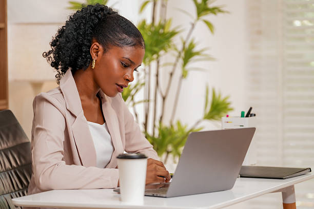 istock Woman engages in creative collaboration with technology while working on laptop in bright office space. Her focused expression reflects strong connection to her tasks 2232914468